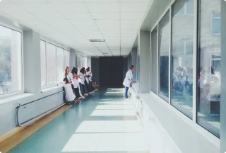 Locum physician observing a procedure through an ICU window, symbolizing the challenges of benzodiazepine withdrawal.